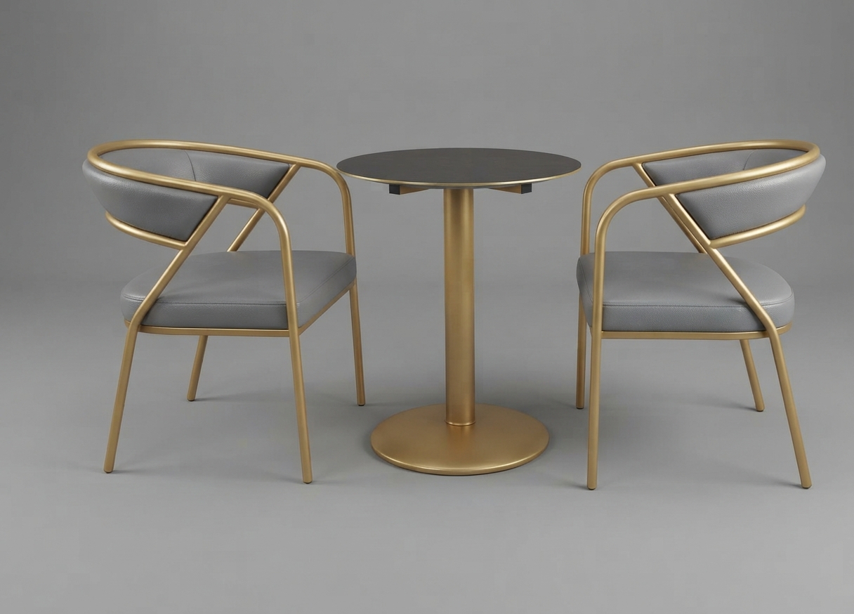 Two brass frame armchairs and a round pedestal table