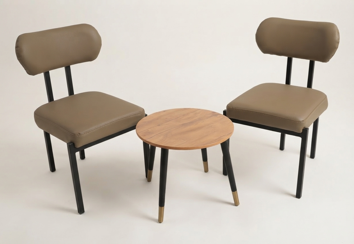 Two tan leather side chairs with a round wooden table