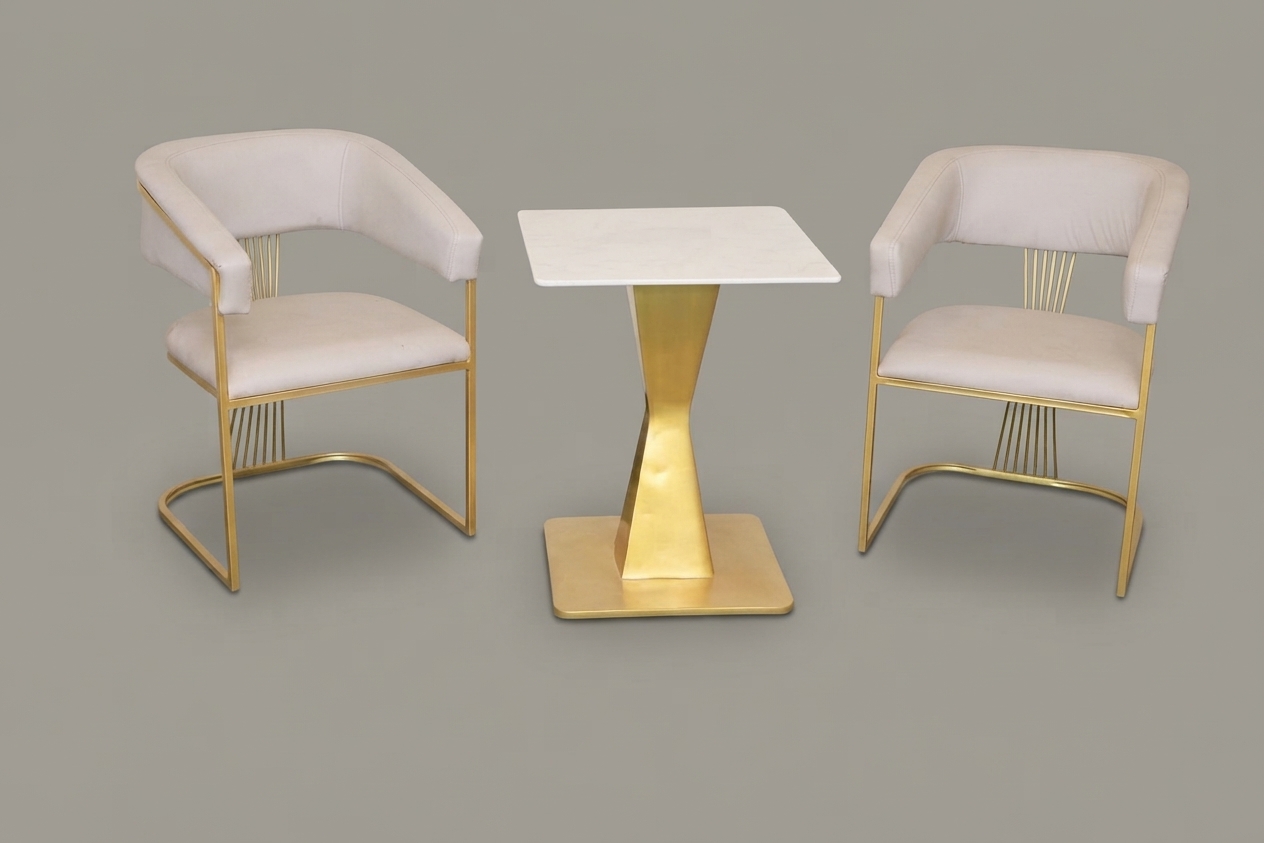 Ivory upholstered chairs with brass frames and a pedestal table