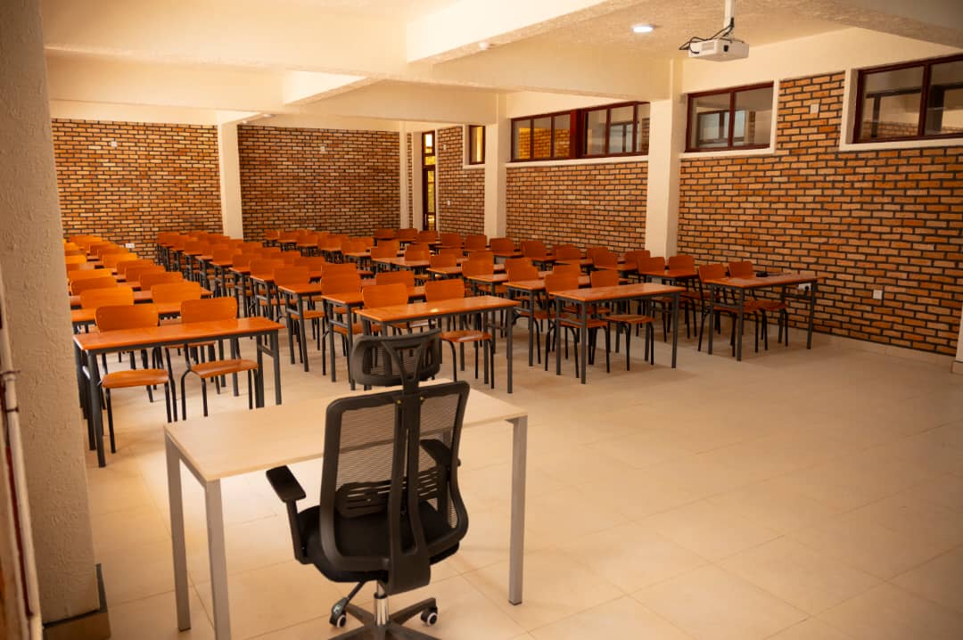 Lecture hall filled with orange desks and chairs